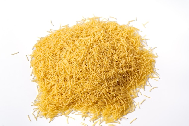 Photo heap of raw small pasta on a white background top viewcopy space