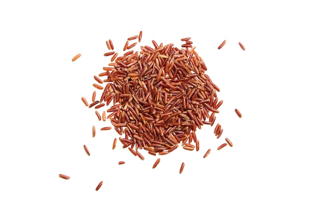 heap of red rice isolated on white background. dry uncooked grains of a cereal plant, top view