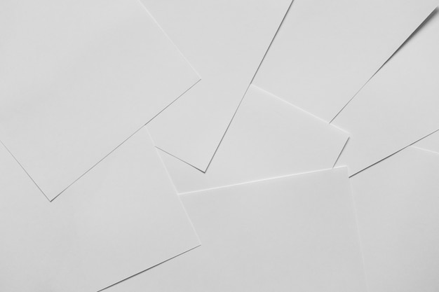 Heap of scattered white empty clean blank paper sheets. Top view, horizontal.