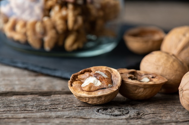 Heap of splited walnuts on rustic wooden table