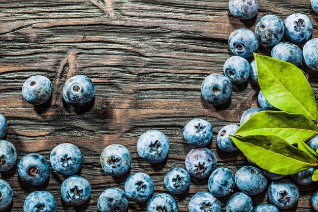 Heap of sweet bilberries on vintage wooden background