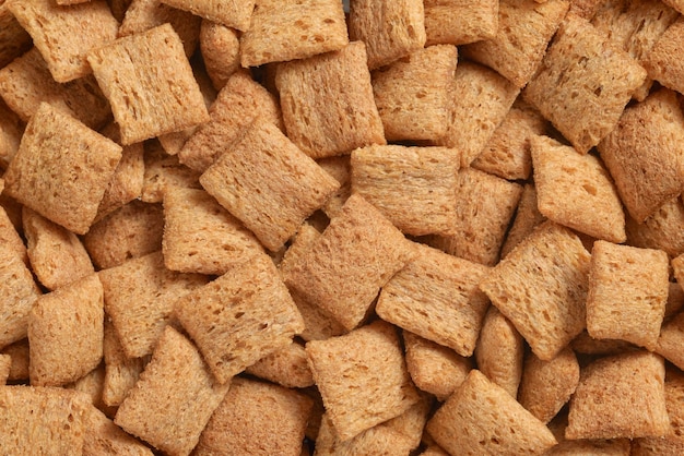 Heap of sweet breakfast cereal pads texture or background