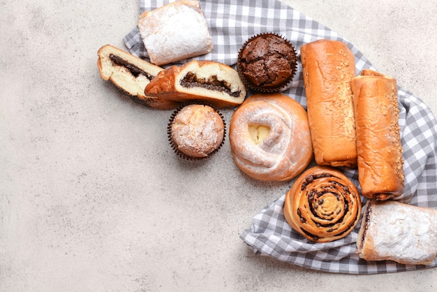 Heap of tasty pastries on grey