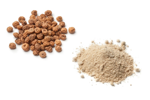 Heap of tigernut flour and tigernuts isolated on white background