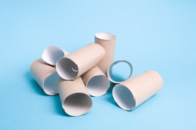 Heap of toilet paper bushes on a blue background a slide of cardboard bushes toilet paper has run out