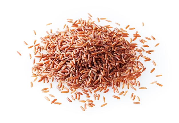 Heap of uncooked red rice isolated on white background