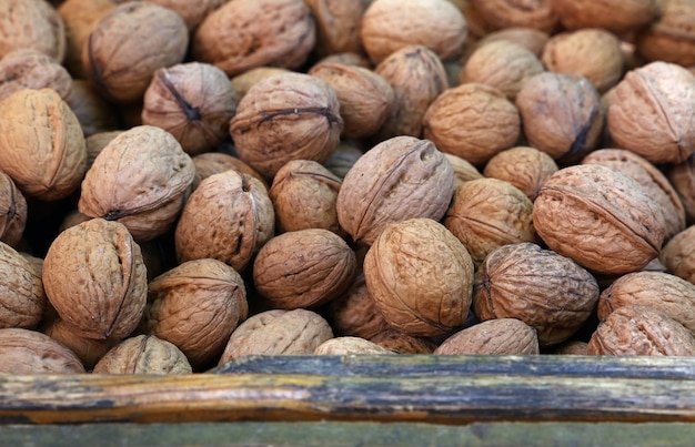 Heap of whole walnuts in wooden box