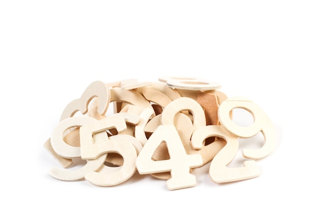 A heap of wooden numbers on a white bckground