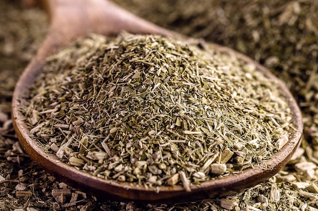 heap of yerba mate with wooden spoon Typical hot drink herb