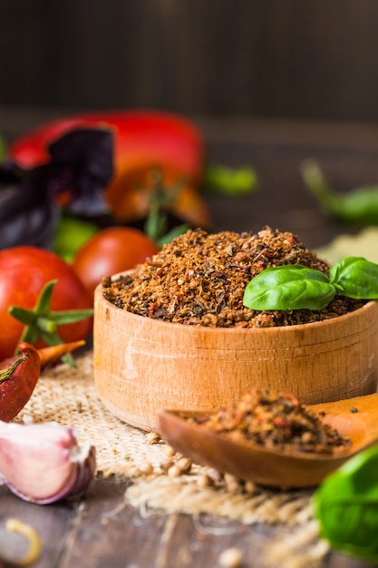 Heaps of various ground spices on wooden wall. Georgian spices, Indian spices, Arabian spices. Spice variety. Herbs and spices