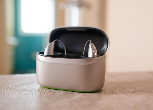 hearing aid devices resting inside charging case on table