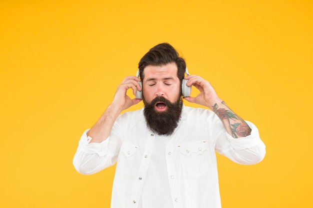 Hearing problem bearded man headphones modern wireless
headphones dance music tracks ears health loud music active noise
cancellation technology hipster listen music stereo headphones