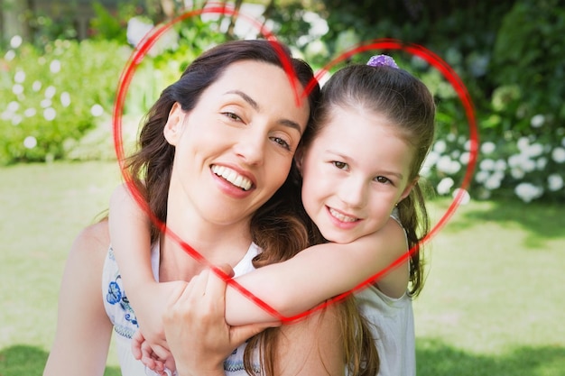 heart against mother and daughter smiling at camera