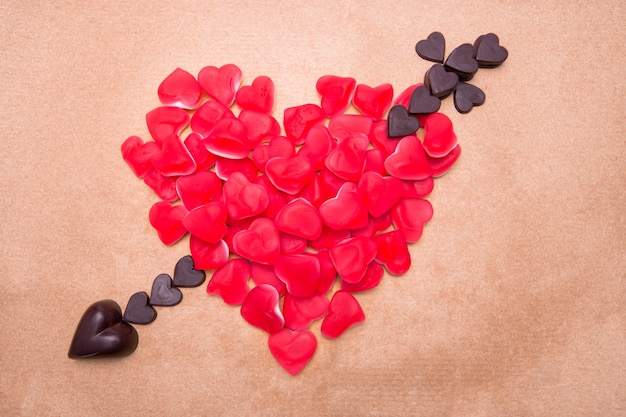 Heart and arrow shaped from candy and chocolate