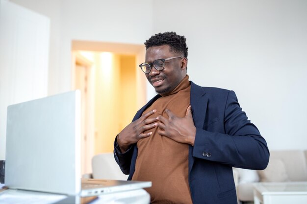 Heart attack Young businessman holding his chest feeling pain on his heart b