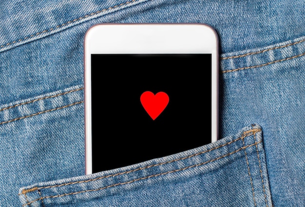 Heart on background phone on jeans love and valentine concept