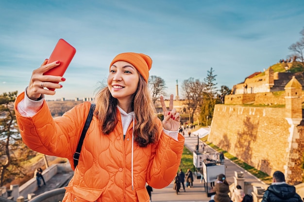 In the heart of Belgrades Kalemegdan a young woman captures the citys charm on her smartphone blending modern technology with historic beauty