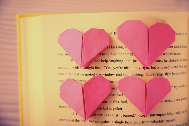 Heart bookmark for book on wooden table top view