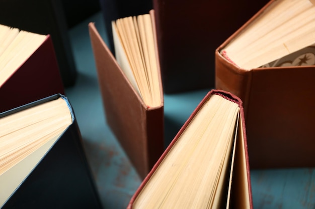 Heart of books on wooden background