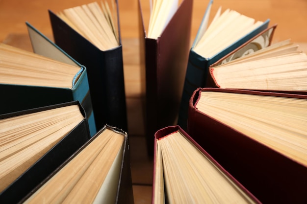 Heart of books on wooden background