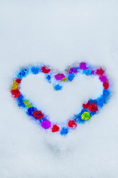 Heart of color gems on snow