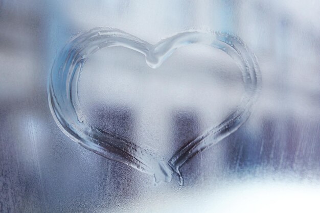 Heart drawn on the fogged glass window