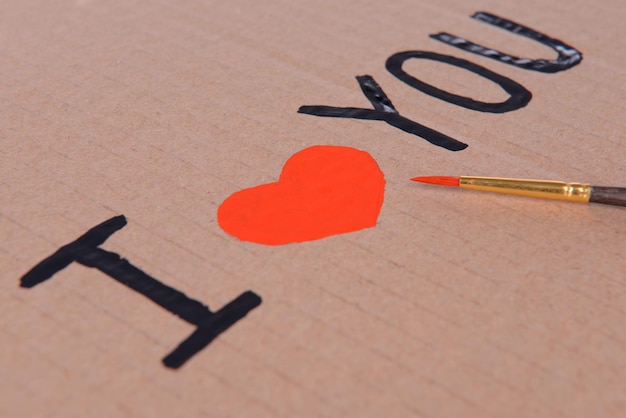 Heart drawn in pencil on a paper sheet close-up