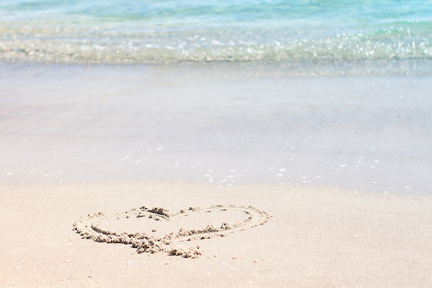 Heart drawn on a sandy  beach