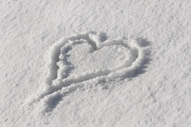 Photo heart drawn in the snow background for valentines day