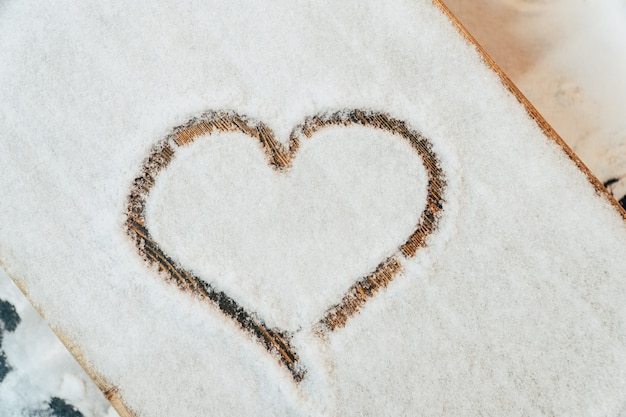 A heart drawn with a finger on the snow