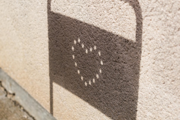 Heart engraved on an outdoor chair with a funny shadow cast by the sun love concept