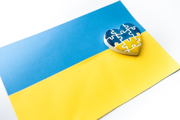 Heart in the form of puzzles with the colors of the flag of Ukraine