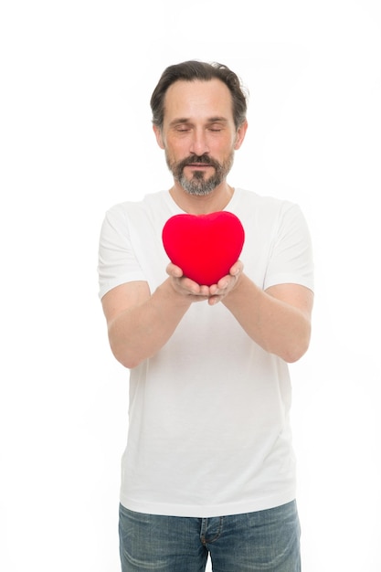Heart gift or present. Greeting from sincere heart. Man bearded hipster hold heart. Celebrate valentines day. Love and romantic feelings concept. Fall in love. Me to you. Heart attribute of valentine.