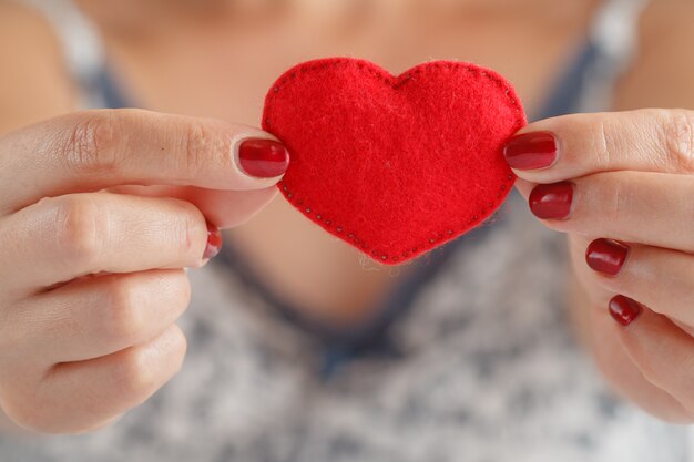 Heart in the hands of woman