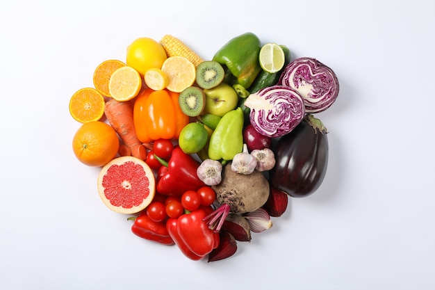 Heart laid out of vegetables and fruits on white 