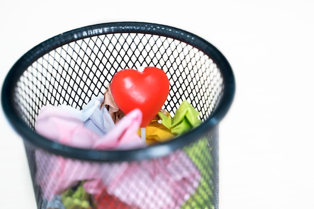 Heart lollipop in a basket full of colorful papers