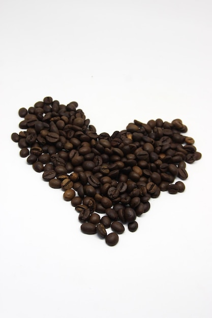 a heart made of coffee beans with a heart drawn in the middle