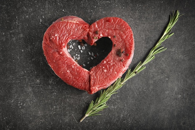 Photo heart made of fresh raw meat on table