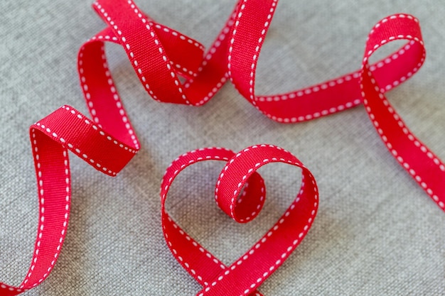 Photo heart made from red ribbon on linen fabric valentines day concept