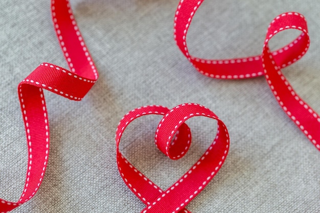 Photo heart made from red ribbon on linen fabric valentines day concept