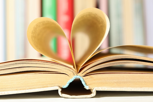 Heart made of pages. book on white table, close up