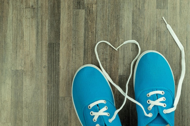 Heart made of white laces on sneakers as a background with place for text