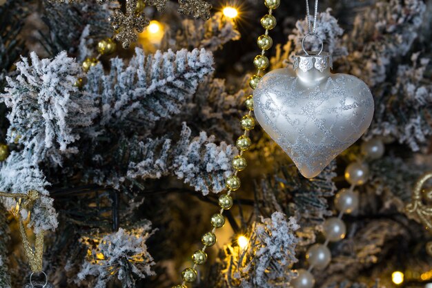 heart ornament hanging from a Christmas tree