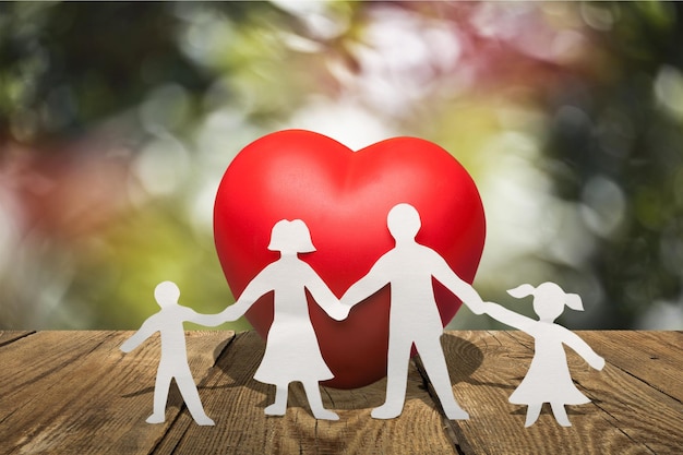 Heart and paper family  on wooden table