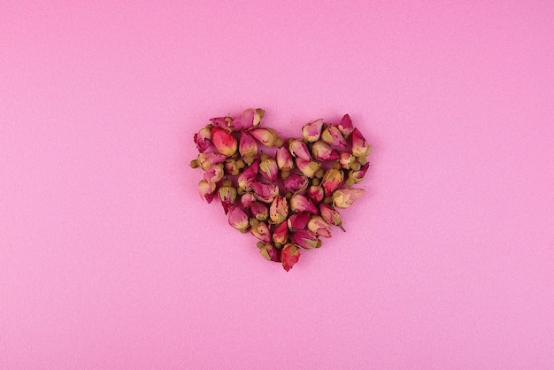 Heart of pink buds on a pink background