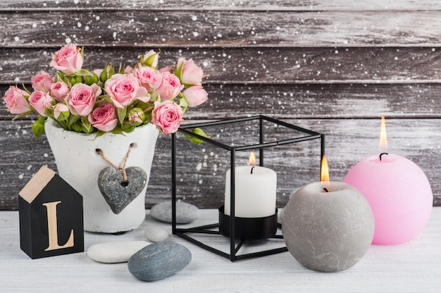 Heart, pink roses in concrete pot with candles