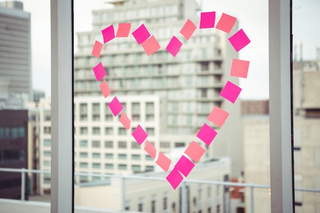 Heart in post-it on a window