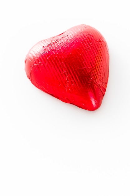 Heart shape chocolate candies wrapped in red foil for Valentine's Day.