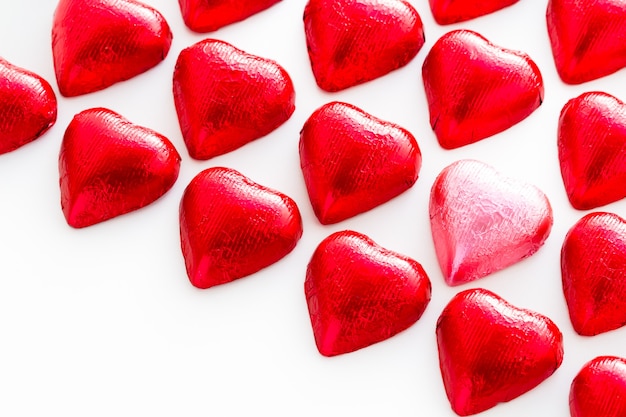 Heart shape chocolate candies wrapped in red foil for Valentine's Day.