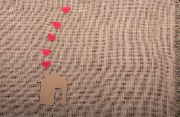 Heart shape coming out of chimney of paper house